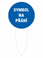 Blue circular sign reading 'SYMBOL NA PŘÁNÍ' mounted on a white stake, indicating a symbol is available on request