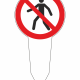 Pedestrian prohibited sign mounted on a stake, showing a person icon with a red slash through it