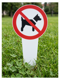 No dogs allowed sign posted in a grassy park distance image area.